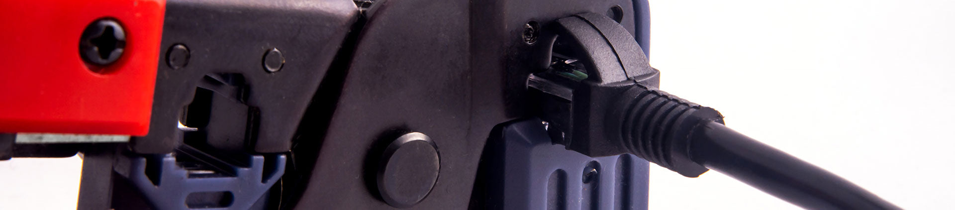 Close-up image of a crimping tool in use, securing an RJ45 connector to a black Ethernet cable, highlighting the precision and functionality of the tool against a light background.