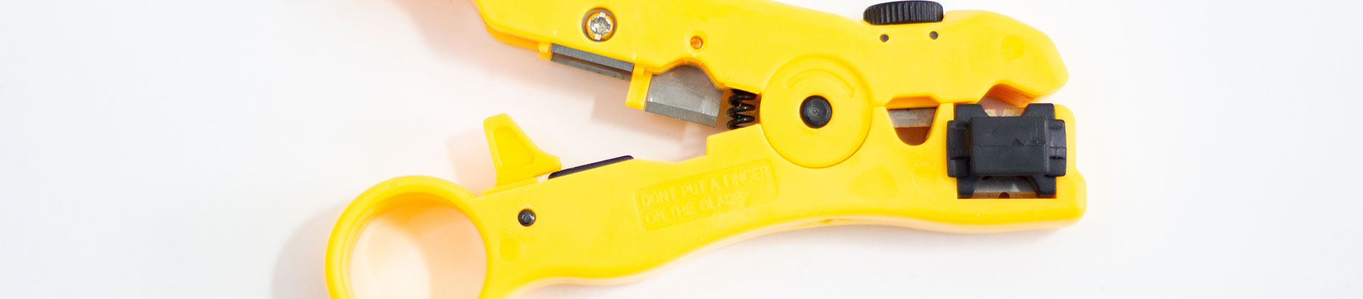 Close-up image of a yellow cable stripping tool with a black adjustment dial, designed for precise and efficient removal of cable insulation, shown on a white background.