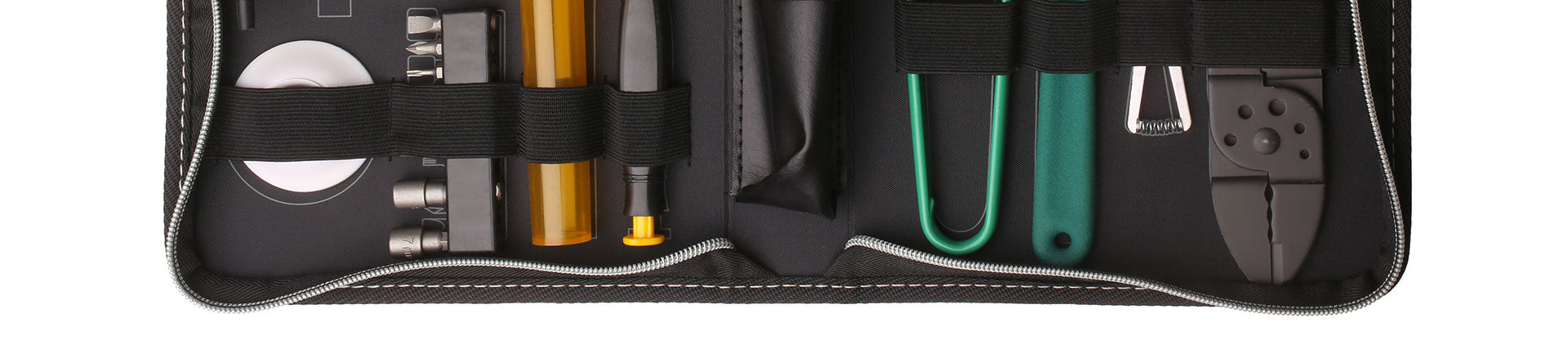Close-up image of a network tool kit neatly organized inside a black zippered case, featuring tools like pliers, screwdrivers, cable strippers, and connectors, secured with elastic straps.