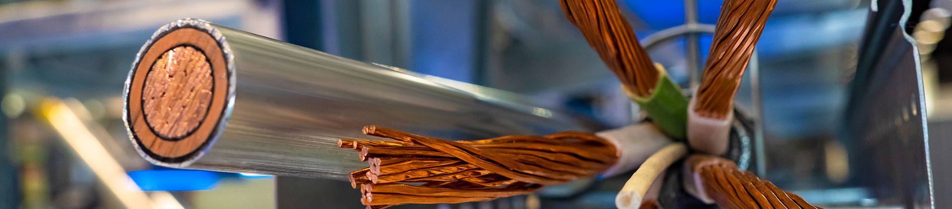 Close-up view of a cross-section of a copper cable showing its detailed internal structure, including tightly wound copper strands and outer insulation, emphasizing its durability and conductivity for electrical and communication applications.