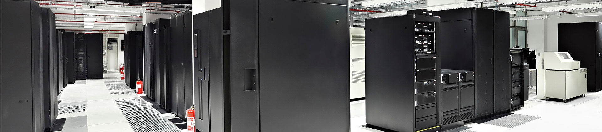A well-organized data center room showcasing rows of sleek black server racks equipped with networking and IT equipment.