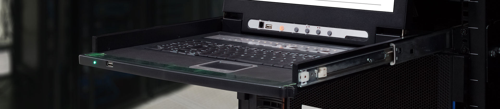 A rack-mounted keyboard drawer with an integrated touchpad is partially extended from a server rack.