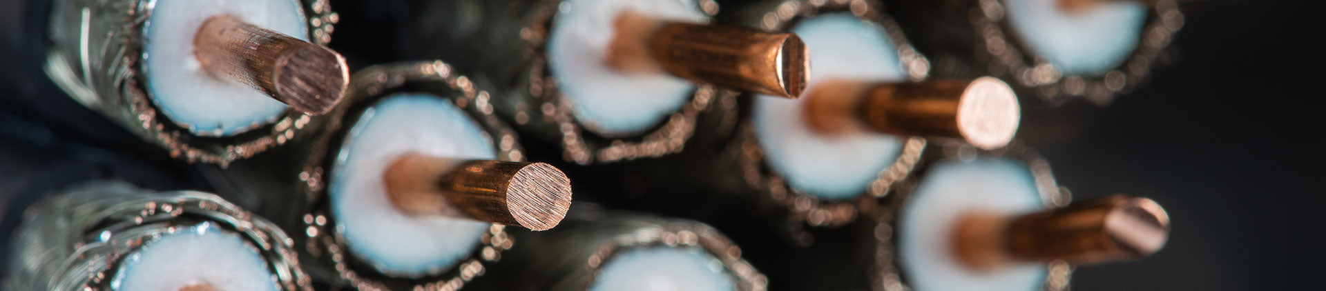 Close-up image of RG11 coax cables with insulation layers, showing the detailed structure and texture of the metallic and insulating materials.