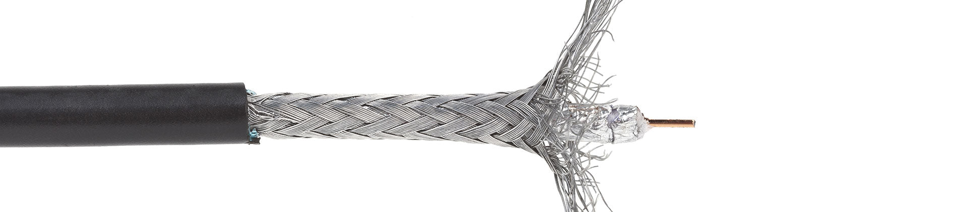 A coaxial cable cut in half showing its inner copper wire and braided shield.