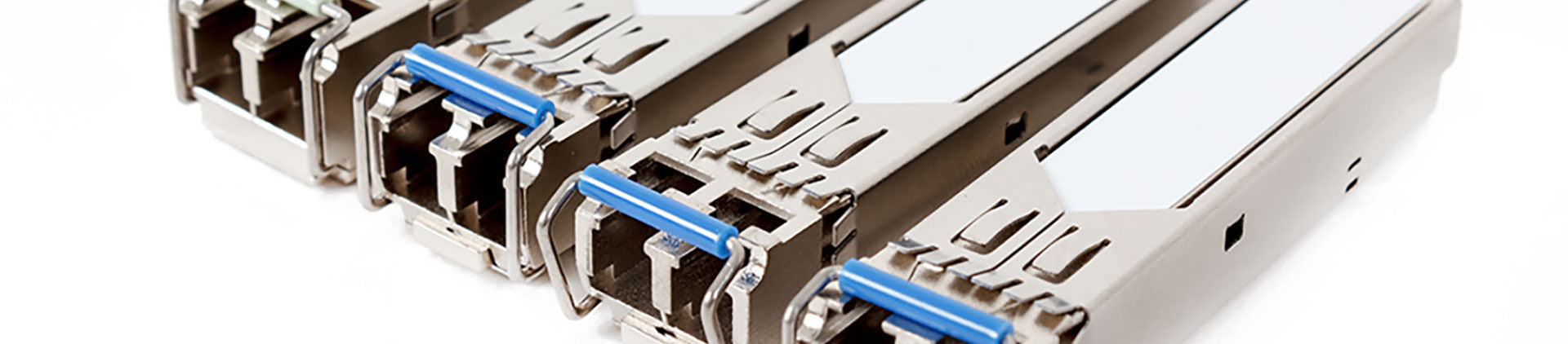 Close-up image of multiple SFP (Small Form-factor Pluggable) modules arranged in a row, showcasing their compact metallic design and blue locking mechanisms, used for high-speed data transmission in networking equipment.