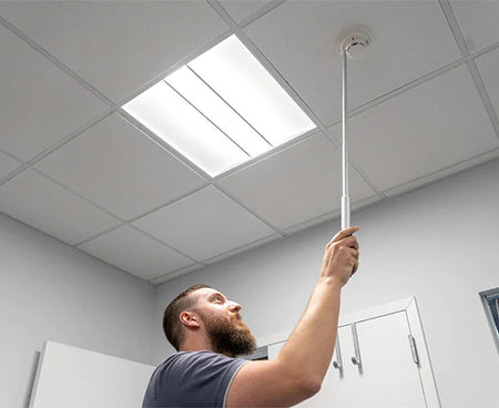 A 5-foot telescoping pole held by a person indoors
