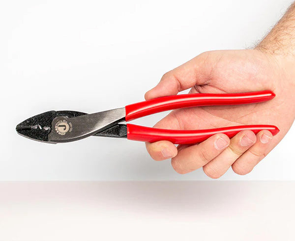 A hand gripping the 9-inch Terminal Crimper & Cutter with red grips