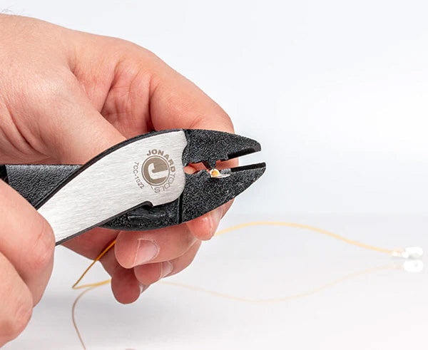 An individual using the 9" Terminal Crimper & Cutter to trim a wire