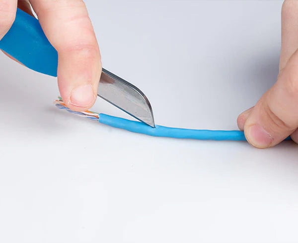 Blue wire being trimmed by professional splicing knife
