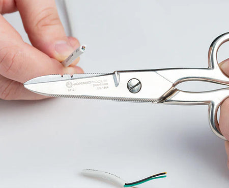 Precise wire cutting with scissors from Network Technician's Kit