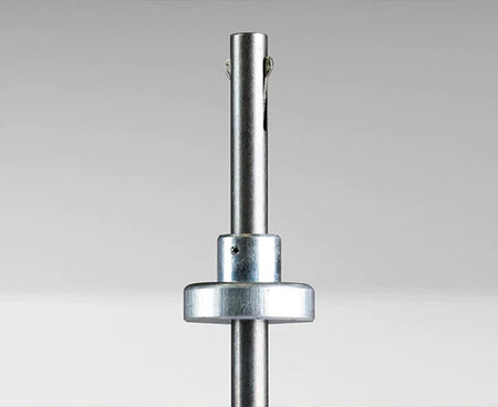 The tip of the 4 1/2" Terminator Tool aligned with a metal screw for installation