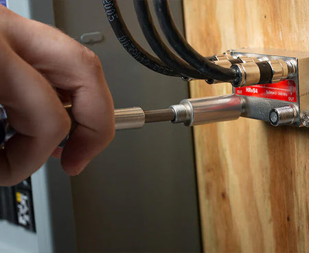 Action shot of the 7" Terminator Tool being used to secure a wire to a wall