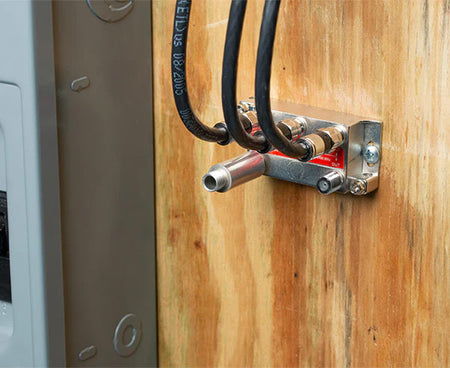 Detailed view of the 7" Terminator Tool's tip with wires and a metal box