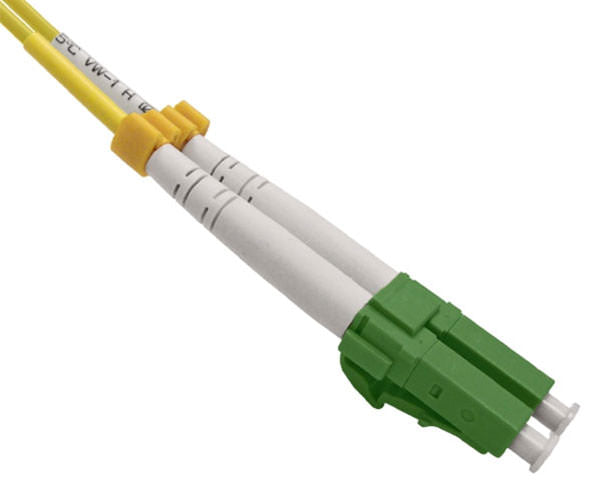 A pair of duplex LC APC connectors with green body and dust caps.