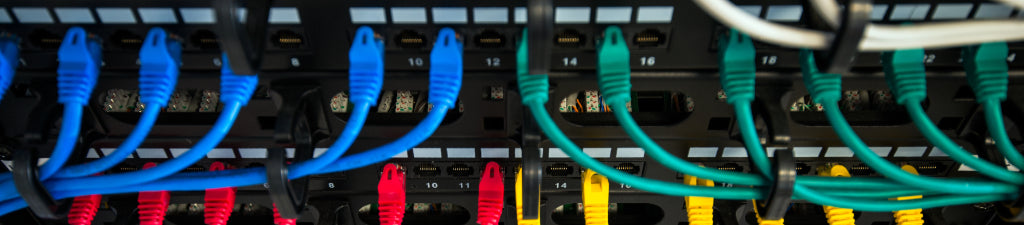 Two network patch panels with colorful patch cables installed.