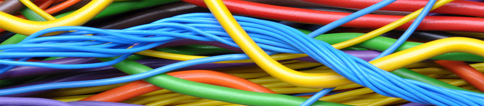 Close-up image of a colorful bundle of cables, including blue, yellow, green, red, orange, and purple wires, showcasing their vibrant insulation and flexibility in a tangled arrangement.