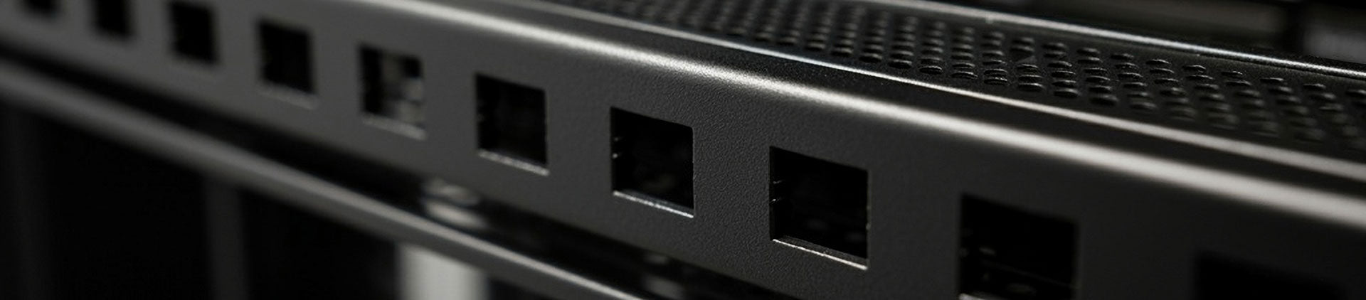 Close-up view of a black metal server rack rail with square mounting holes, designed for securing equipment with cage nuts.