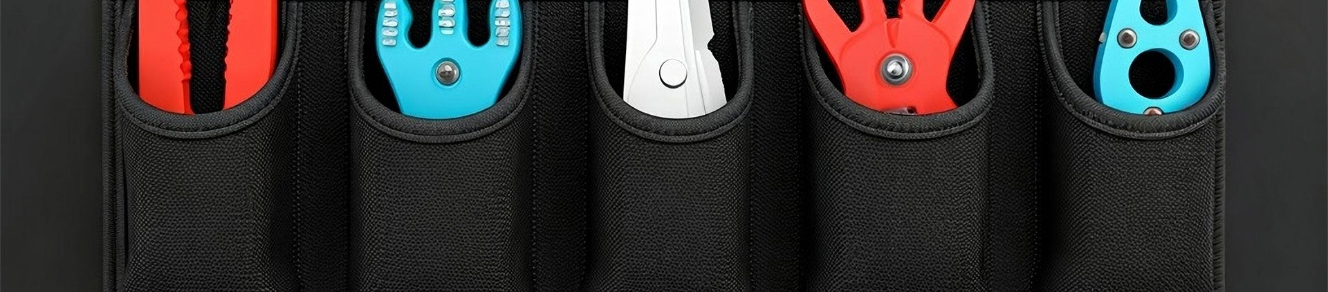 A close-up image showing a durable black tool pouch featuring multiple compartments holding colorful, specialized technical tools.