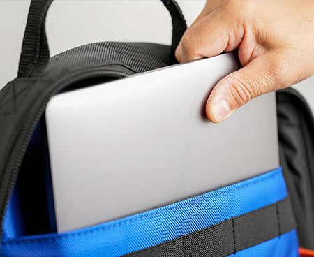 A technician removing a laptop from a specially designed backpack pocket