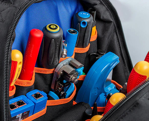 Close-up of a technician's tool bag backpack with various hand tools
