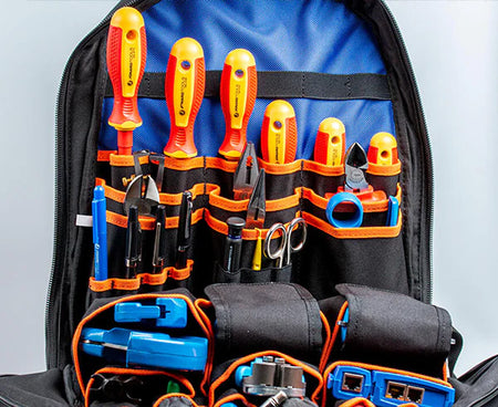 Open view of technician's tool bag backpack showing organized tool compartments