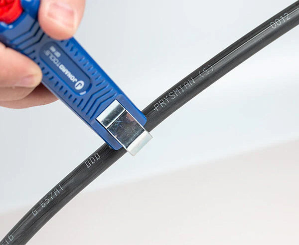 A person stripping insulation from a wire using the Round Cable Strip & Ring Tool