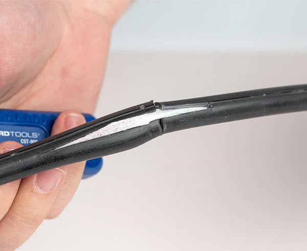 The Round Cable Strip & Ring Tool in action, removing the sheath from a cable