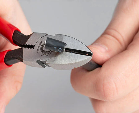 Technician precisely cutting a wire with 6.25" telecom pliers
