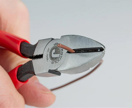 Hand holding 6.25" telecom diagonal cutters about to cut a wire