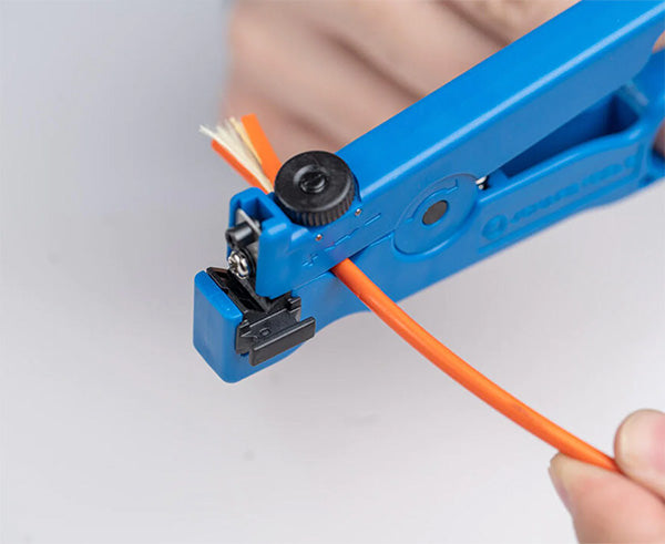 Detail of a wire cutter from the Ultimate Backpack Fiber Prep Kit in use on a cable