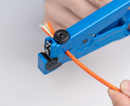Detail of a wire cutter from the Ultimate Backpack Fiber Prep Kit in use on a cable