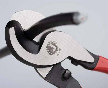 Close-up view of the red-handled pliers from the Ultimate Backpack Fiber Prep Kit
