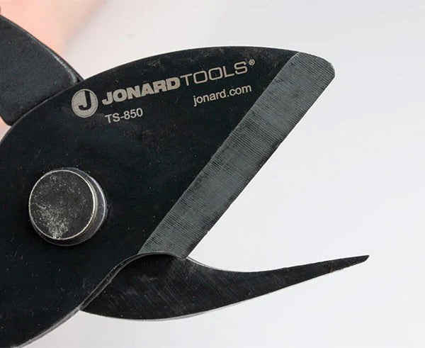 User demonstrating the grip on tabbing shears with red handles