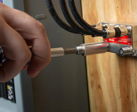 Using the 7 1/2" Terminator Tool to secure a cable against a wall