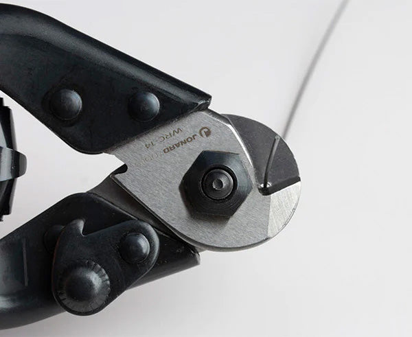 Close-up of the handheld wire cutter with black and metallic components