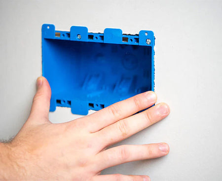 Hand holding the Wall Box Template & Level to showcase its portability and ease of use