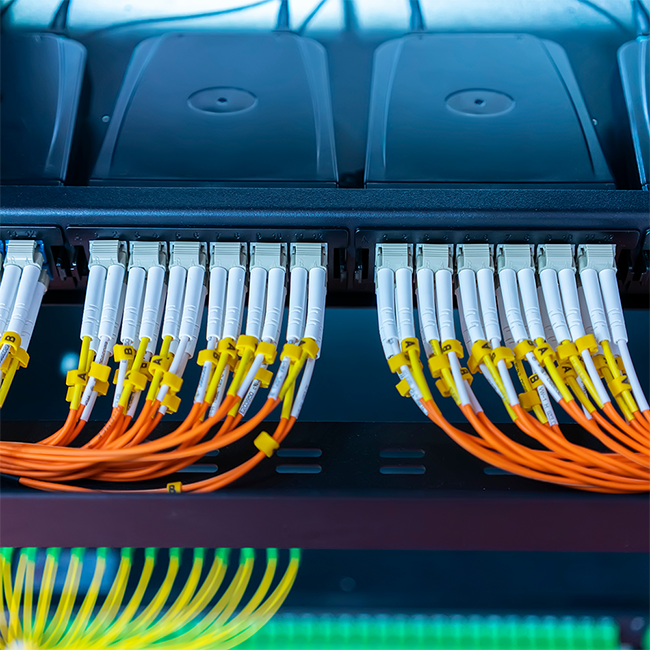 Close-up of fiber optic cables connected to a network switch.
