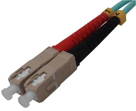 Two SC OM3 connectors on aqua fiber with dust caps.
