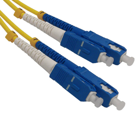 Four SC single-mode OS2 connectors on yellow fiber.