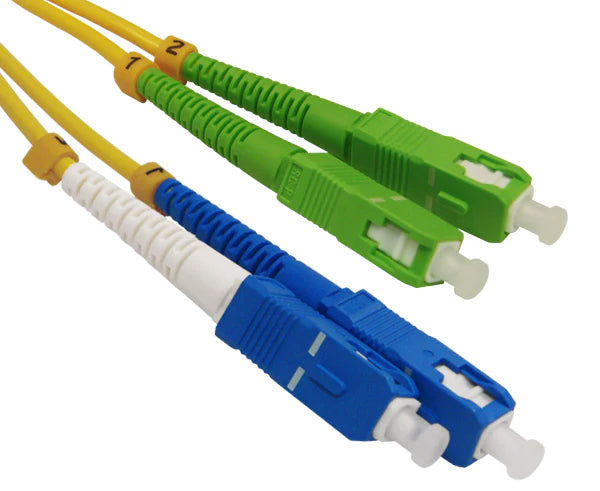 A pair of SC OS2 APC connectors with green body and a pair of SC OS2 UPC connectors with blue body.