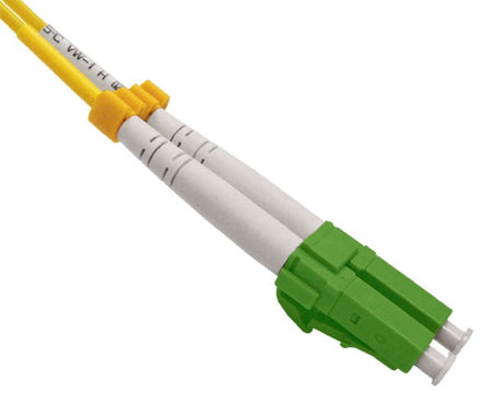 A single LC single-mode APC connector with green body and dust caps.