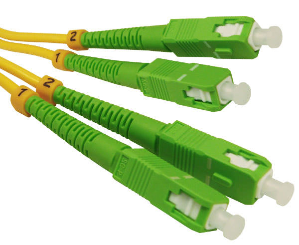A pair of SC OS2 APC connectors with yellow fiber, green body and dust caps.